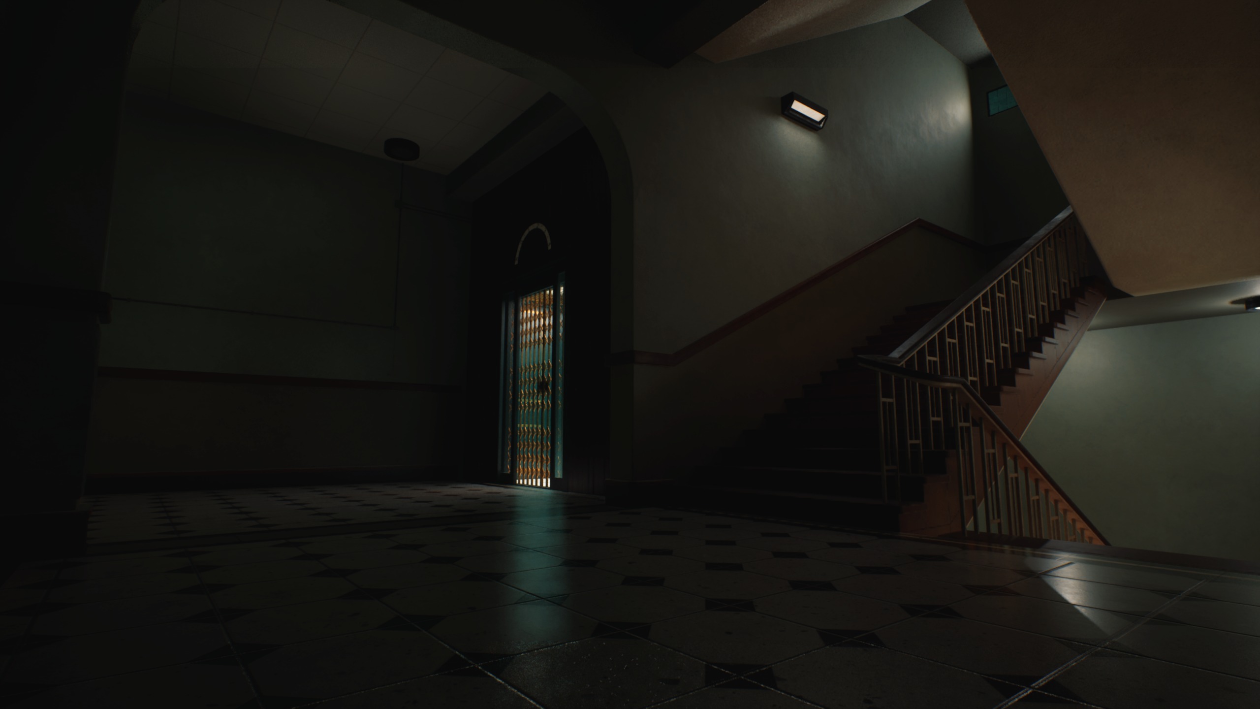 Dimly lit hospital stairwell beside a closed elevator
